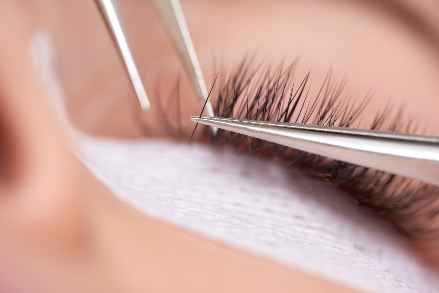 macro shot of application of false eyelashes