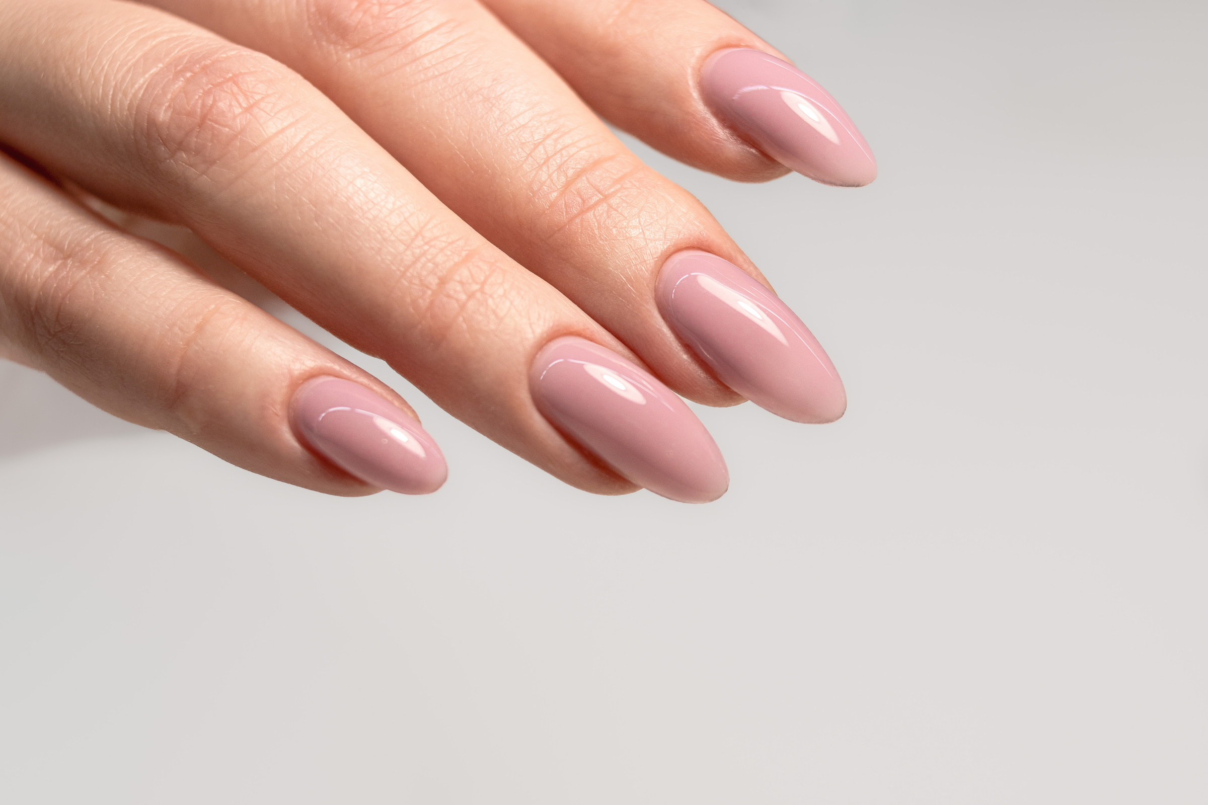 Beautiful manicure with pink nude gel polish.  Long almond nails.  Perfect nude manicure