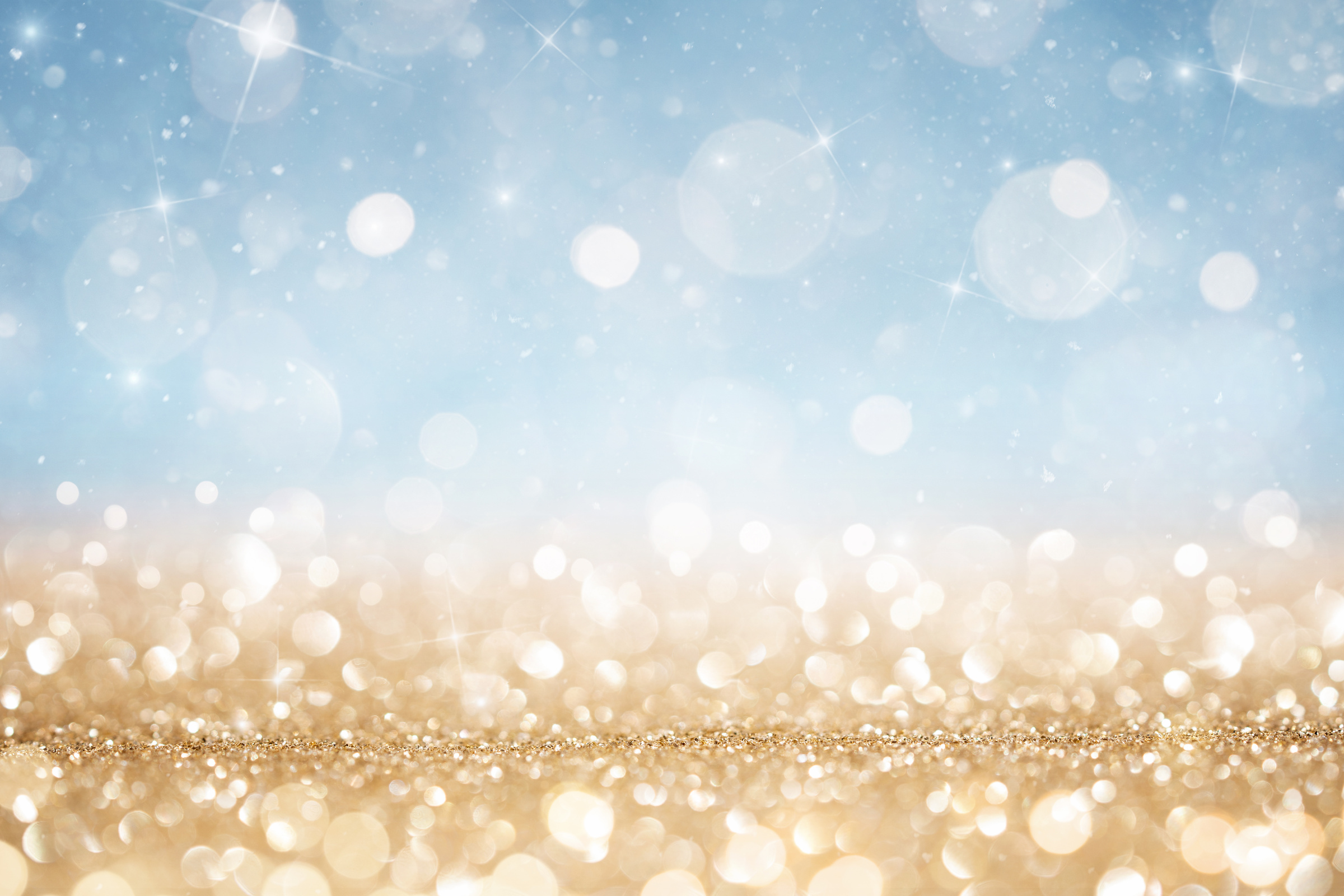 Abstract defocused gold and blue glitter background