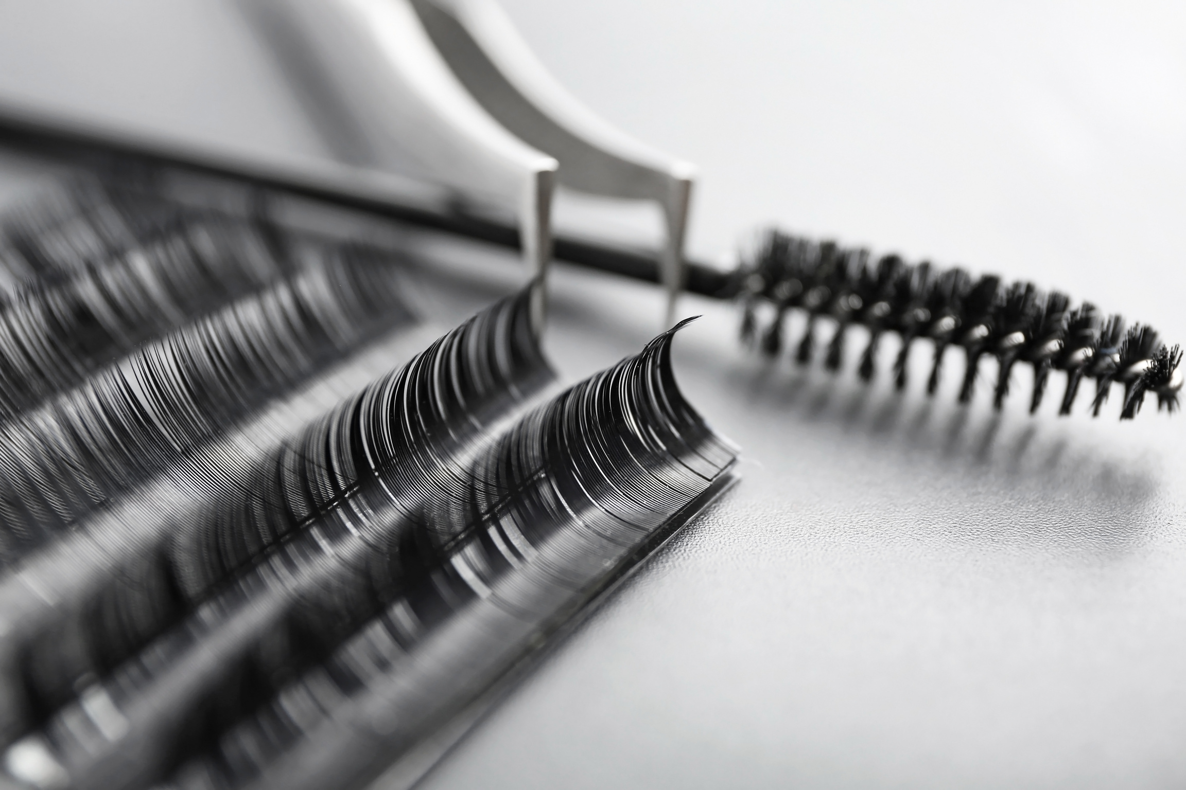 Set of Eyelash Extensions on Grey Background, Closeup